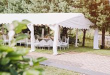 A white, open-air event tent rental set-up