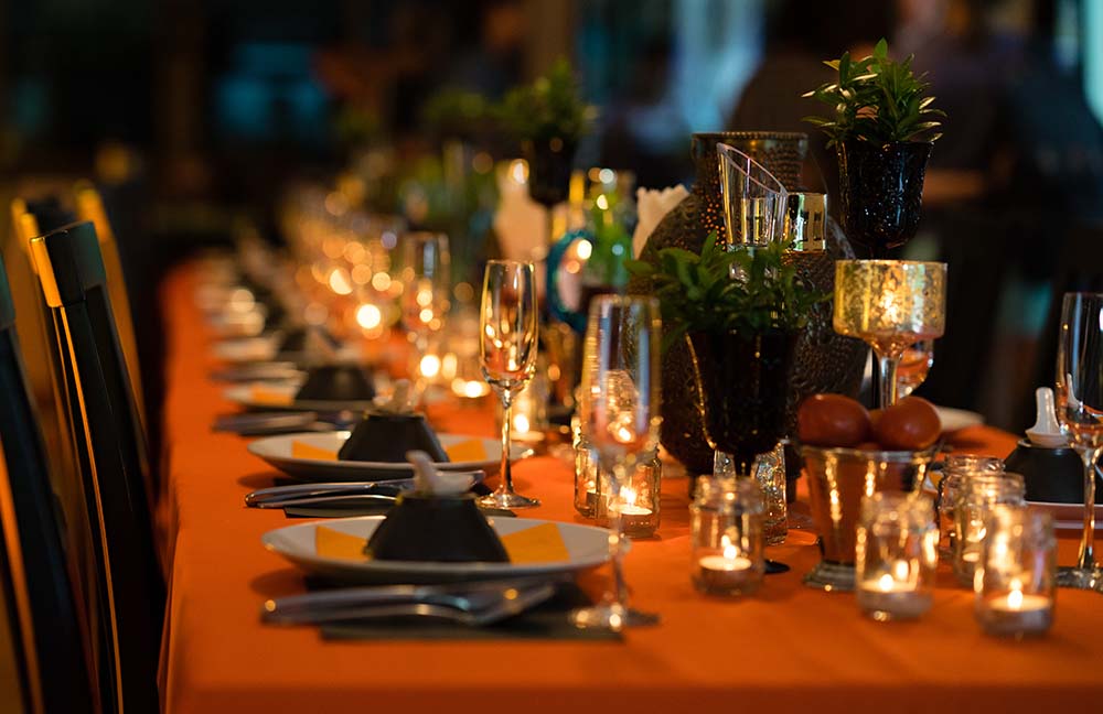 An atmospheric Thanksgiving table with a burnt orange linen tablecloth