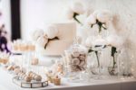 A beautiful wedding cake table decorated with glass and flowers