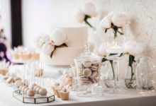 A beautiful wedding cake table decorated with glass and flowers