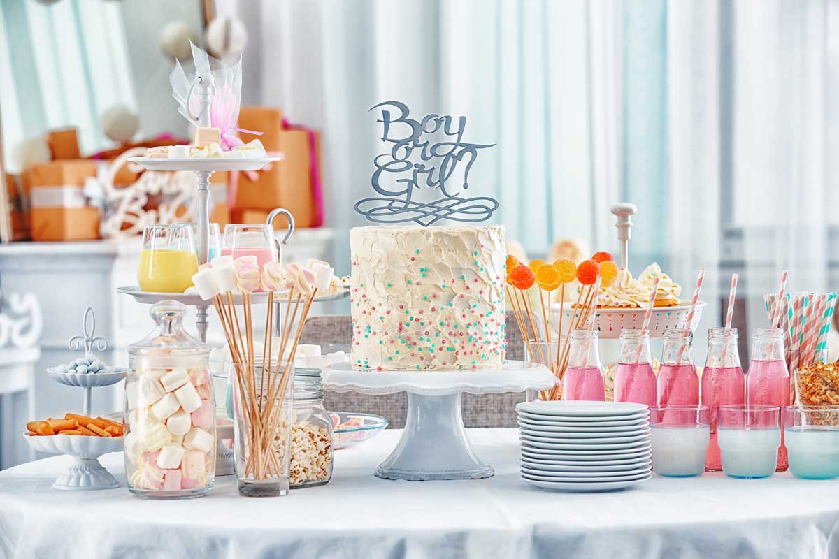 A gender-reveal-themed dessert table at a baby shower